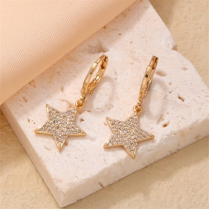 Detail of star-shaped earrings in gold-plated brass with micro-pave cubic zirconia