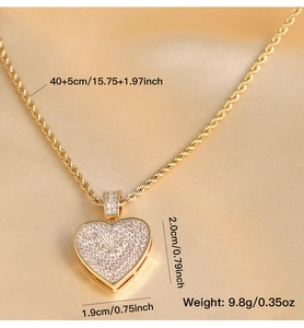 Detail of hip hop gold heart pendant with cubic zirconia on silk champagne background