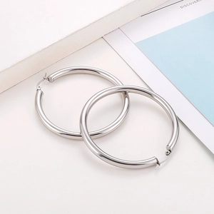 Minimalist silver round hoop earrings for women shown against a clean white background