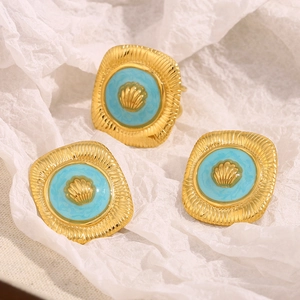 Detailed macro view of 18K gold plated square ring and earrings set with shell pattern