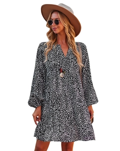 Detail of V-neckline and lantern sleeves on a black and white polka dot mini dress