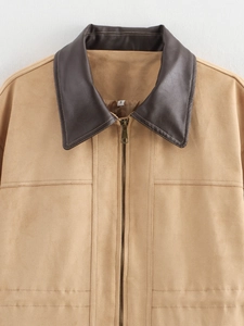 Close-up of contrast collar and metal zipper on suede long coat with stitching detail