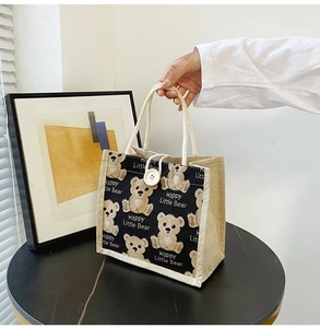Detailed macro view of a linen lunch bag with a cute bear print and text Happy Little Bear
