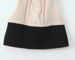 Detail shot of knitted cable texture and smooth fabric in beige and black patchwork