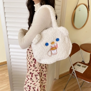 Close-up of cute white faux shearling tote bag featuring detailed cartoon bear embroidery
