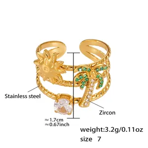 Detail van een 18k vergulde ring met palmboom bedeltje en groene zirkoonstenen
