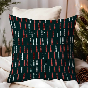 Detail of dark green Christmas tree pillow cover on a cozy bed with pine cones