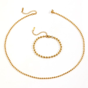 Golden stainless steel bead chain necklace and bracelet jewelry set on white background