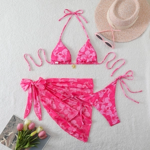 Detailed view of pink floral bikini set with hibiscus print and gold flower charm