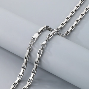 Detail of silver bold rectangular link chain necklace with minimalist industrial design