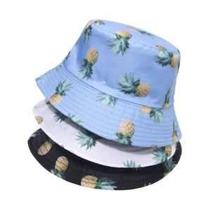 Summer bucket hats in blue, white, and black with tropical pineapple print patterns