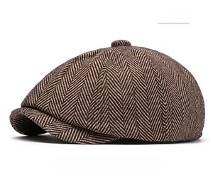 Detailed close-up of khaki herringbone tweed newsboy cap fabric and classic British texture