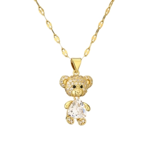 Detail of gold teddy bear pendant with micro-paved zircons and large triangular crystal