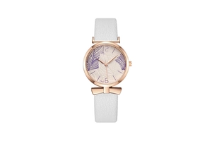 Close-up of rose gold watch with white leather strap and purple leaf pattern dial