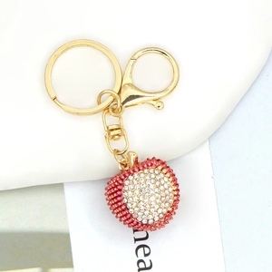 Detailed view of red and white rhinestone lychee keychain with gold metal d-ring and loop