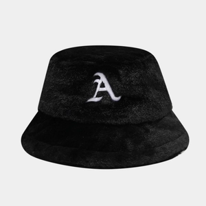 Close-up view of black faux fur bucket hat with white embroidered A letter