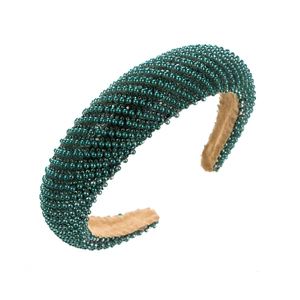 Detail of hand-beaded diagonal weave headband with deep green pearls and velvet lining