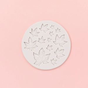 Detailed white silicone mold featuring eleven various maple leaf patterns for fondant cake decor