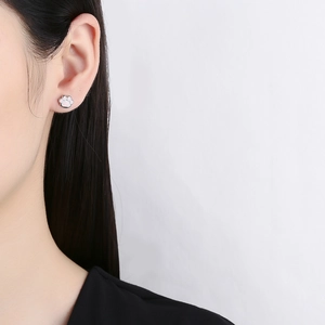 Cute pink cat paw earrings in 925 sterling silver worn by a model for a minimalist look