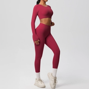 Detail of red yoga set with long sleeve crop top thumb holes and high waist leggings
