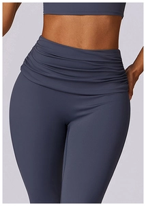 Detail view of high waist yoga pants featuring ruching and tummy control design