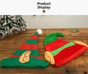 Detail of Christmas elf hats with yellow ears on a rustic wooden festive display
