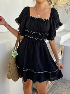 Detail of square neck black dress with white ruffle trim and short puff sleeves for summer
