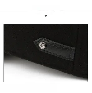 Detail showing the black wool fabric texture and metal logo button on the baseball cap
