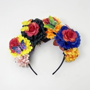 Detail of colorful artificial roses and butterflies on Day of the Dead headband