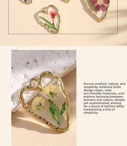 Detailed macro view of heart-shaped resin earrings with real dried daisy flowers and gold trim