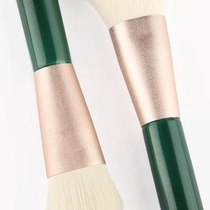 Deep green makeup brush set with rose gold tubes and soft white synthetic bristles