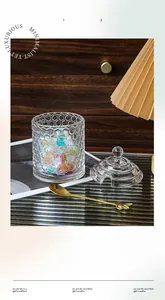 Macro detail of honeycomb glass jar with golden spoon and elegant sphere handle lid