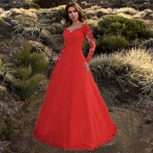 Detail of red lace long sleeve evening gown with intricate floral patterns and V-neckline