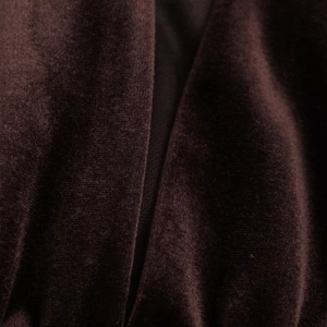 Detailed close-up of dark brown velvet fabric showing soft texture and premium quality