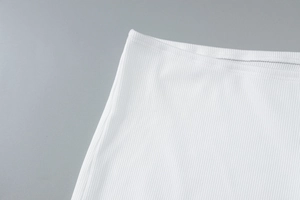 Close-up of white ribbed knit fabric texture showing high-quality fiber details