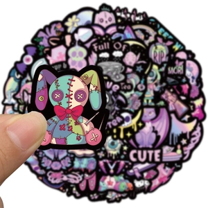 Close-up of gothic waterproof cartoon stickers showing creepy cute purple bunny and skull