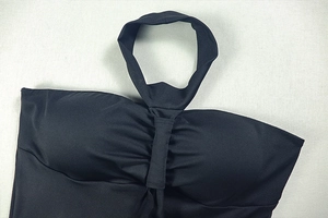 Detail of black halter neckline design with gathered pleat texture on the chest area