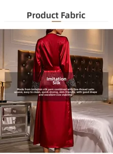 Detail of red silk satin robe sleeves featuring intricate black lace trim and smooth texture