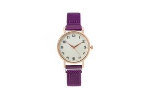 Detail of rose gold quartz watch with purple magnetic Milanese strap and numeric dial