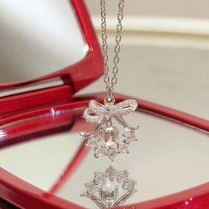 Elegant silver lily wreath necklace with bow pendant and sparkling zircons in a red gift box