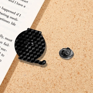 Detailed back view of a black enamel pin with grid texture and butterfly clutch