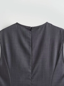 Detail of high-waist sleeveless dress showing the back invisible zipper and woven fabric
