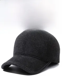 Detail of grey wool blend baseball cap with a metal shield logo and thick texture