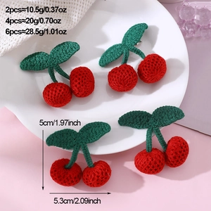 Detail of 4 knitted cherry hair clips with dimensions and weight specs on a white plate