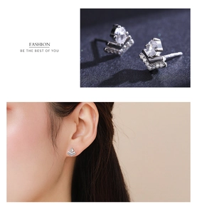Macro shot of V-shaped S925 silver earrings with sparkling pavé and oval zircon stone