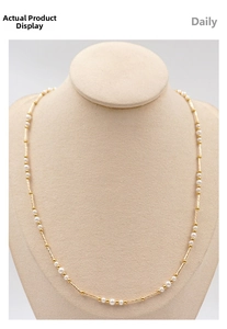Detail of French vintage pearl necklace with gold beads and tubes on a beige bust stand