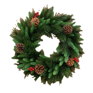 Christmas wreath with dense pine needles, natural cones and red berries on white background