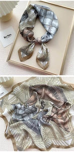Detail of vintage square silk scarf with brown weave print and elegant rolled edges