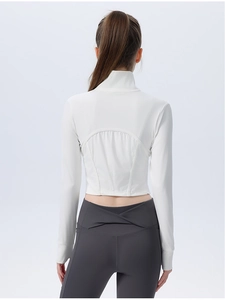 Detail of white ribbed yoga top with back seam design and high waist cross leggings
