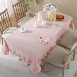 Detailed view of pink washed cotton tablecloth with elegant ruffled pleated edges